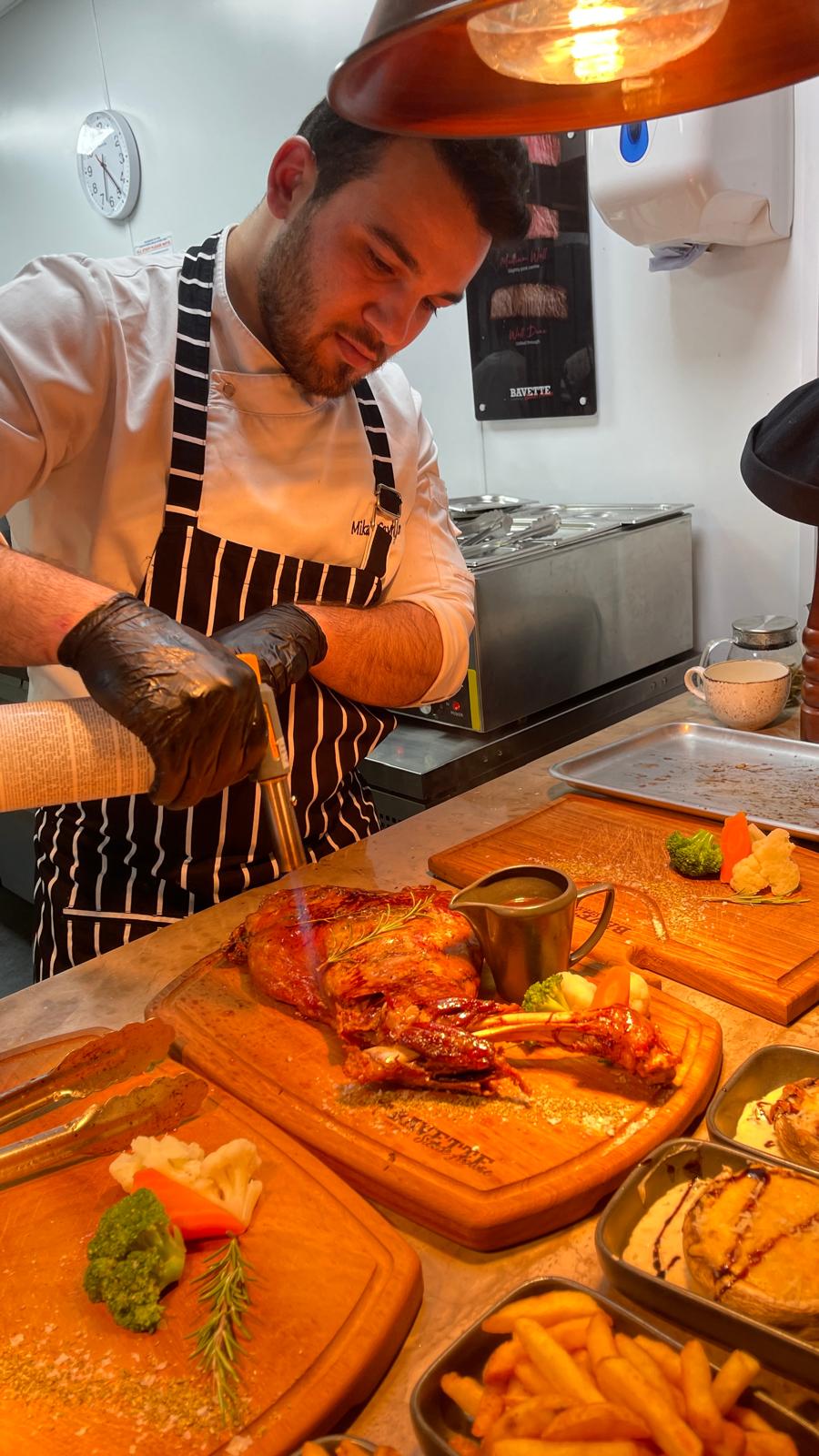Glazed lamb shoulder being finished with a blowtorch
